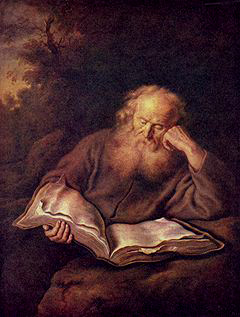 an old man reading a large book, looking thoughtful
