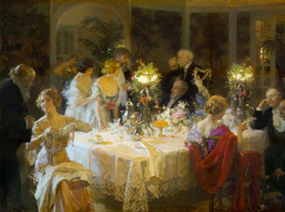 a group of people standing around a dinner table, talking