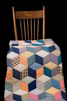 quilt laid over a rocking chair